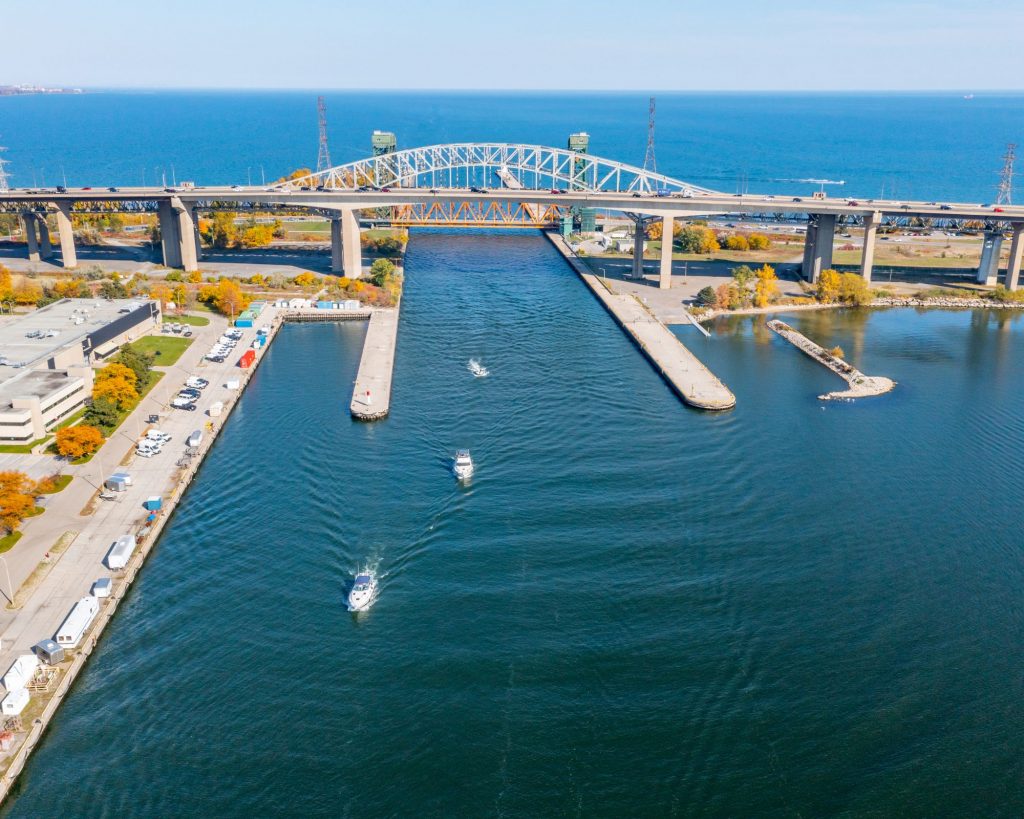 Scenic view of the Burlington Bay Canal during autumn, featuring calm waters framed by vibrant fall leaves, creating a picturesque setting that highlights the beauty of the changing season.