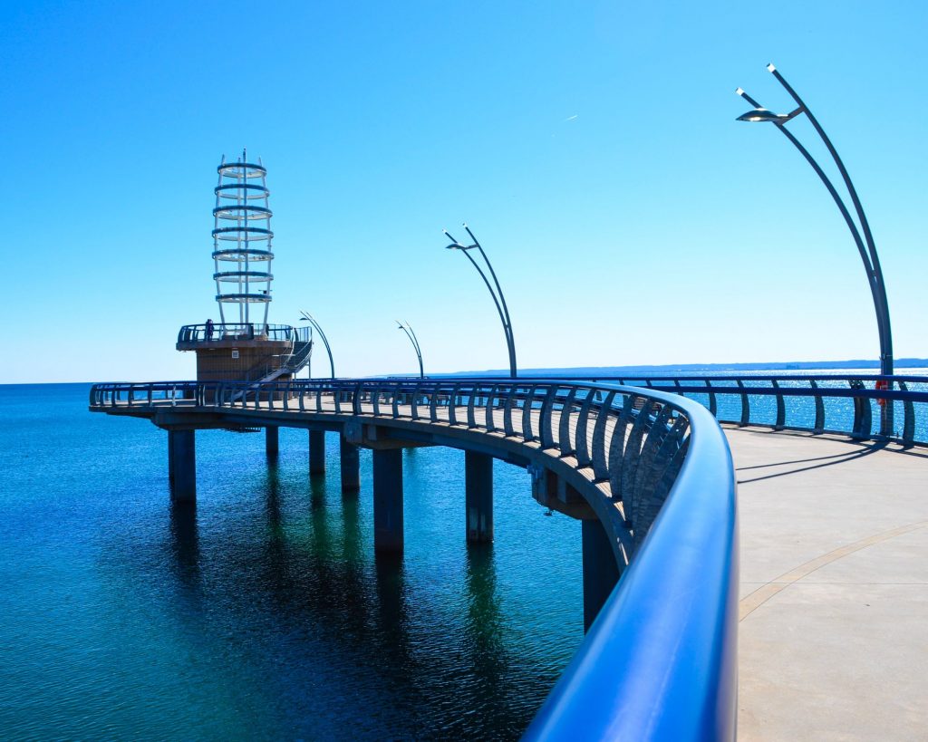 Brant Street Pier in Burlington, Ontario, with its modern architectural design extending over Lake Ontario on a clear day.